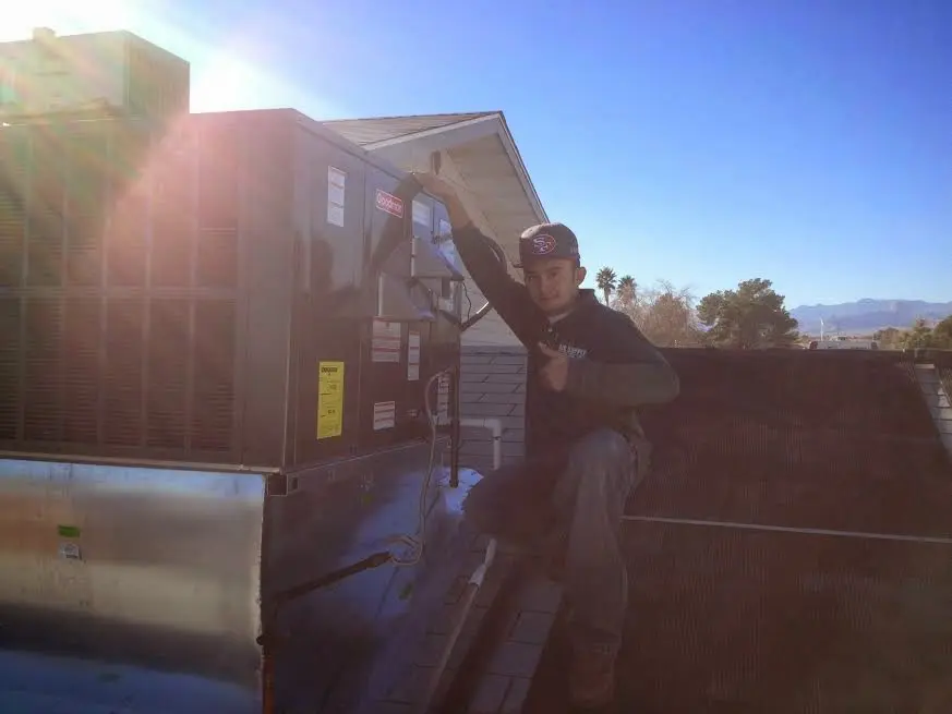 HVAC technician performing HVAC Inspection on a rooftop unit in Ocean Pines